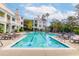 Attractive pool area with lounge chairs and views of the surrounding buildings and palm trees at 130 River Landing Dr # 7309, Charleston, SC 29492
