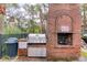 Outdoor grilling area with stainless steel grill and brick structure at 130 River Landing Dr # 7309, Charleston, SC 29492