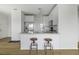 Modern kitchen with stainless steel appliances, granite countertops, and center island with bar stool seating at 130 River Landing Dr # 7309, Charleston, SC 29492