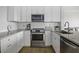 Modern kitchen features stainless steel appliances, granite countertops, and white subway tile backsplash at 130 River Landing Dr # 7309, Charleston, SC 29492