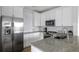 Modern kitchen with stainless steel appliances, granite countertops, and white cabinetry at 130 River Landing Dr # 7309, Charleston, SC 29492