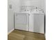 Laundry room featuring a full sized washer and dryer set with ample shelving at 130 River Landing Dr # 7309, Charleston, SC 29492