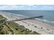 Beautiful beach with pier, highlighting the ease of access to oceanfront amenities and recreational activities at 1300 Ocean Blvd # 102 A, Isle of Palms, SC 29451
