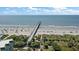 Panoramic aerial view of the beach with pier, showcasing the property's stunning oceanfront location at 1300 Ocean Blvd # 102 A, Isle of Palms, SC 29451