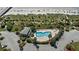 Aerial view of the complex pool, showcasing lounging areas, lush landscaping, and proximity to the sandy beach at 1300 Ocean Blvd # 102 A, Isle of Palms, SC 29451