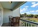 Relax on this private balcony with seating, offering a tranquil view of the lush landscape and beach access at 1300 Ocean Blvd # 102 A, Isle of Palms, SC 29451