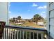 Sunny balcony view overlooking palm trees, a boardwalk, and a path to the beach at 1300 Ocean Blvd # 102 A, Isle of Palms, SC 29451
