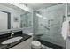 Bathroom featuring a large shower with marble tile and a black granite vanity at 1300 Ocean Blvd # 102 A, Isle of Palms, SC 29451