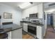 Bright kitchen with stainless steel appliances, black granite counters and white cabinets at 1300 Ocean Blvd # 102 A, Isle of Palms, SC 29451