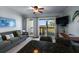 Cozy living room with a view of the balcony, featuring an outdoor table and chairs at 1300 Ocean Blvd # 102 A, Isle of Palms, SC 29451
