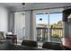 Bright living room featuring sliding glass doors leading to a balcony with scenic outdoor views at 1300 Ocean Blvd # 102 A, Isle of Palms, SC 29451