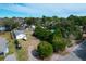 Wide aerial view of a property featuring mature trees, outbuildings, and a home with a garage and boat storage at 1328 Erckmann Dr, Mount Pleasant, SC 29464
