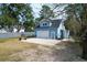 Garage with a large concrete apron, surrounded by a fence and various trees at 1328 Erckmann Dr, Mount Pleasant, SC 29464