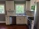 Updated kitchen with white cabinets, stainless steel appliances, tile backsplash, and hardwood floors at 1328 Erckmann Dr, Mount Pleasant, SC 29464