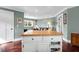 Open-concept living area with wood floors, neutral walls, and a functional kitchen island at 1328 Erckmann Dr, Mount Pleasant, SC 29464