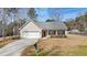 Charming one-story home featuring a well-manicured front yard and an attached two-car garage at 144 Cinnamon Rd, Summerville, SC 29483
