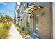 Modern townhome exterior shows brick facade with covered entry, complemented by manicured landscaping along the sidewalk at 1515 Hidalgo Dr, Mount Pleasant, SC 29464