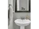 Clean pedestal sink in a well-lit bathroom at 1556 Cranes Nest Rd, Mount Pleasant, SC 29466