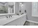 Bright bathroom featuring a double vanity with white countertops, mirrors, and brushed nickel fixtures at 1556 Cranes Nest Rd, Mount Pleasant, SC 29466