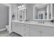 Bright bathroom featuring a double vanity with white countertops and a gray tile floor at 1556 Cranes Nest Rd, Mount Pleasant, SC 29466