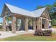 Community pavilion with brick columns, metal roof, picnic tables and outdoor seating area at 1556 Cranes Nest Rd, Mount Pleasant, SC 29466