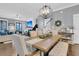 Spacious dining room with a large table, chandelier, and open layout to the living room at 1556 Cranes Nest Rd, Mount Pleasant, SC 29466