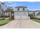 Charming home with a two-car garage, well-manicured lawn, and mature palm trees at 1556 Cranes Nest Rd, Mount Pleasant, SC 29466