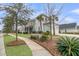 Charming home with a two-car garage, well-manicured lawn, and mature palm trees at 1556 Cranes Nest Rd, Mount Pleasant, SC 29466