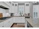 Spacious white kitchen with an island, granite countertops, stainless steel appliances, and modern lighting at 1556 Cranes Nest Rd, Mount Pleasant, SC 29466