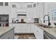 Well-lit kitchen featuring white cabinets, granite counters, stainless sink, and tiled backsplash at 1556 Cranes Nest Rd, Mount Pleasant, SC 29466