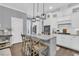 Bright kitchen featuring a large island, granite countertops, pendant lighting, and white cabinetry at 1556 Cranes Nest Rd, Mount Pleasant, SC 29466