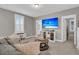Living room features a large TV screen, sofa and bright light at 1556 Cranes Nest Rd, Mount Pleasant, SC 29466
