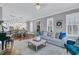 Open-concept living room with fireplace, piano, and view into the dining area at 1556 Cranes Nest Rd, Mount Pleasant, SC 29466