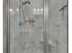 Shower with glass door featuring a built-in seat, gray tile surround, and brushed nickel fixtures at 1556 Cranes Nest Rd, Mount Pleasant, SC 29466