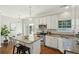 Bright kitchen featuring granite countertops, stainless steel appliances, white cabinetry, and island seating at 1582 Harborsun Dr, Charleston, SC 29412