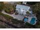 Sprawling two-story coastal home with a pool, patio, lush landscaping, and a paver driveway at 1648 Home Farm Rd, Mount Pleasant, SC 29464