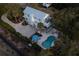 Aerial view of a coastal home featuring a pool, patio, and lush landscaping at 1648 Home Farm Rd, Mount Pleasant, SC 29464