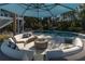 Backyard with a seating area around a fire pit, and an umbrella providing shade at 1648 Home Farm Rd, Mount Pleasant, SC 29464