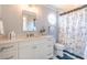 Nautical themed bathroom featuring a round window, patterned shower curtain, and white vanity at 1648 Home Farm Rd, Mount Pleasant, SC 29464