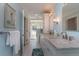 Elegant bathroom with dual vanities, marble countertops, decorative light fixtures, and a walk-in shower for a spa-like experience at 1648 Home Farm Rd, Mount Pleasant, SC 29464