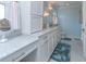 Bright bathroom featuring a double vanity, sleek tile floors, and a separate makeup counter for a touch of luxury at 1648 Home Farm Rd, Mount Pleasant, SC 29464