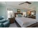 A lovely bedroom featuring a ceiling fan, light blue walls and wood furnishings at 1648 Home Farm Rd, Mount Pleasant, SC 29464