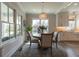 Bright dining room with round wood table, chandelier, and ample natural light at 1648 Home Farm Rd, Mount Pleasant, SC 29464