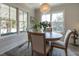 Bright dining room with round wood table, chandelier, and ample natural light at 1648 Home Farm Rd, Mount Pleasant, SC 29464