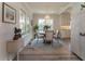 Bright dining room with round wood table, chandelier, and ample natural light at 1648 Home Farm Rd, Mount Pleasant, SC 29464