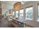 Bright dining area with stylish light fixture, large windows, and hardwood floors at 1648 Home Farm Rd, Mount Pleasant, SC 29464