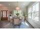 Bright dining room with round wood table, chandelier, and ample natural light at 1648 Home Farm Rd, Mount Pleasant, SC 29464
