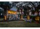 Charming exterior view of home with outdoor bench, showcasing its inviting curb appeal with illuminated walkway and palm trees at 1648 Home Farm Rd, Mount Pleasant, SC 29464
