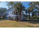 Charming two-story home with double porches surrounded by mature trees and landscaping at 1648 Home Farm Rd, Mount Pleasant, SC 29464