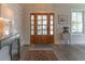 Inviting foyer features wood floors, a stylish console table, and a decorative mirror at 1648 Home Farm Rd, Mount Pleasant, SC 29464